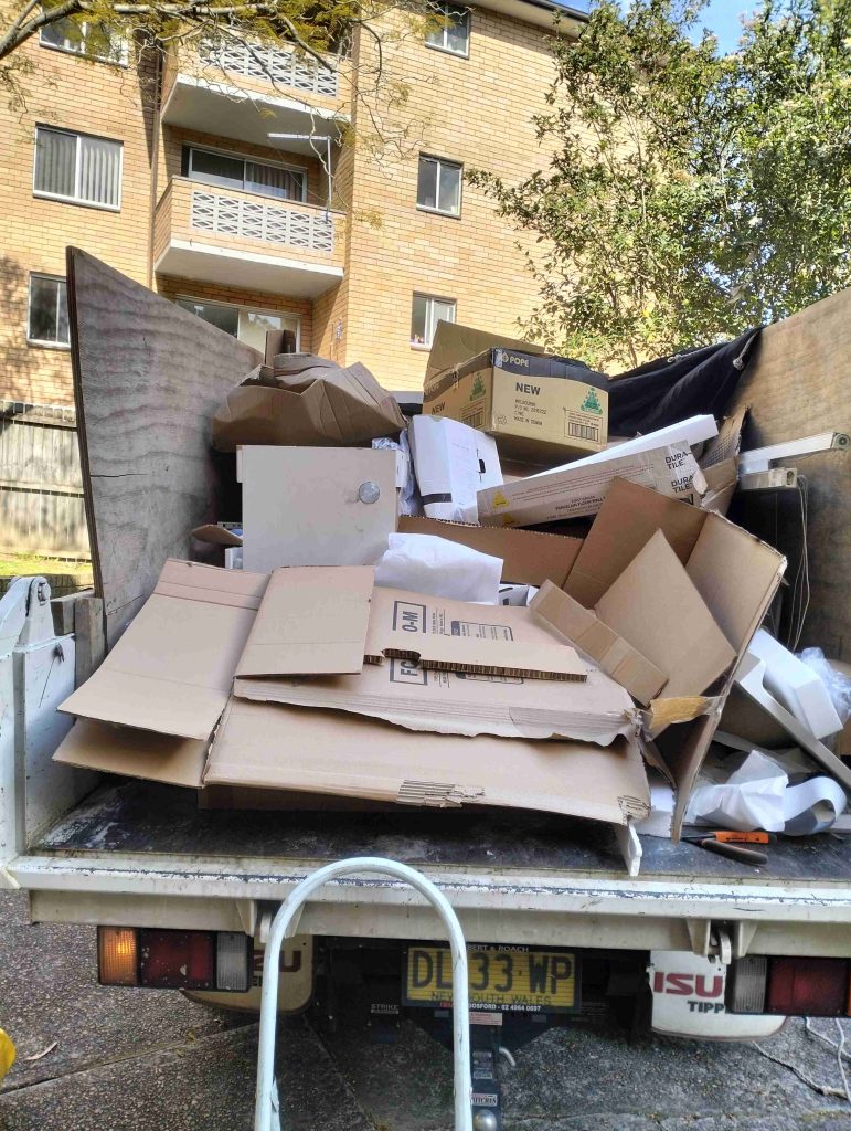 cardboard and packaging on the back of isuzu tipper truck in ryde