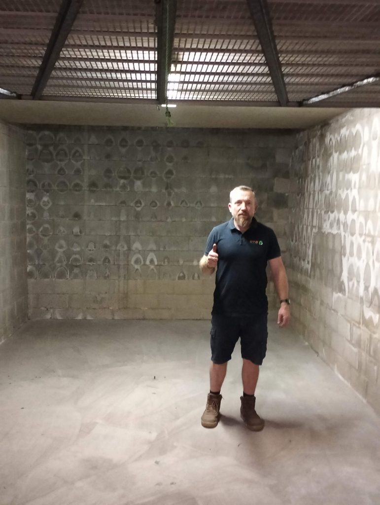 otg team member after a difficult garage clean up empty space with thumbs