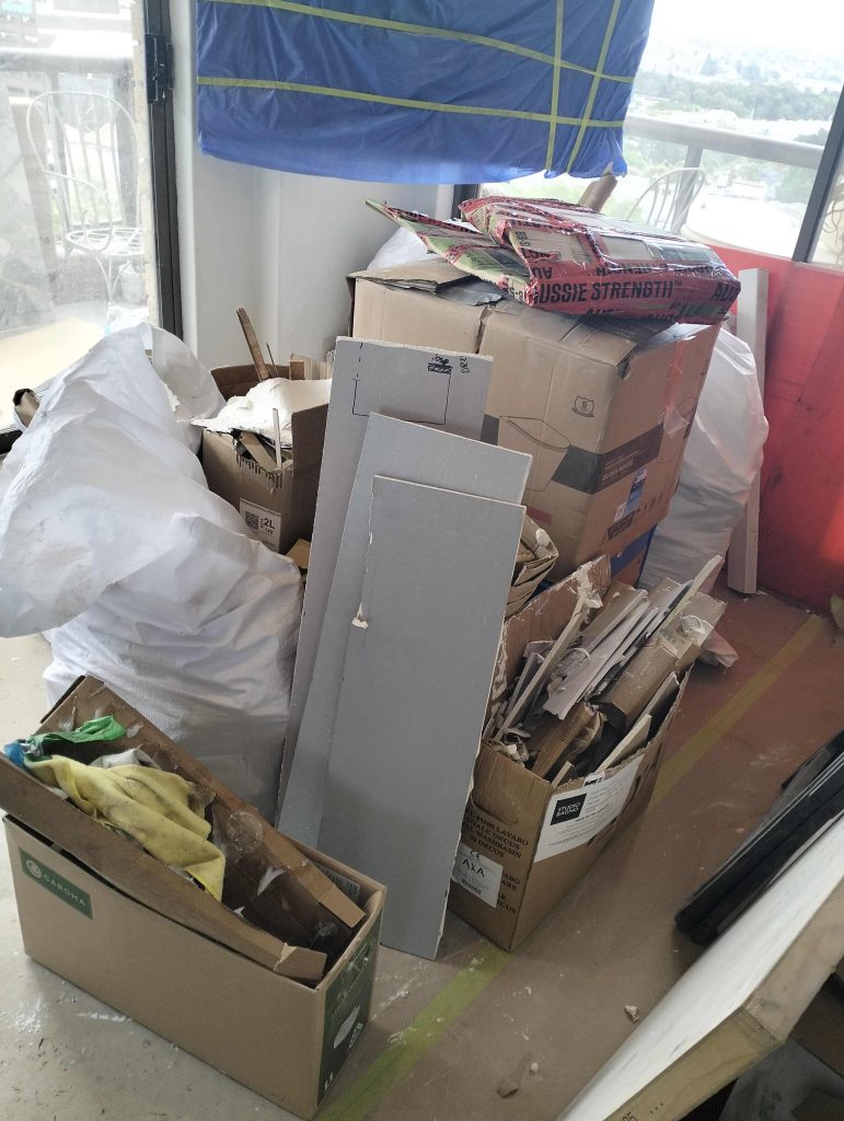 some renovation rubbish in boxes in the corner of a unit in darlinghurst
