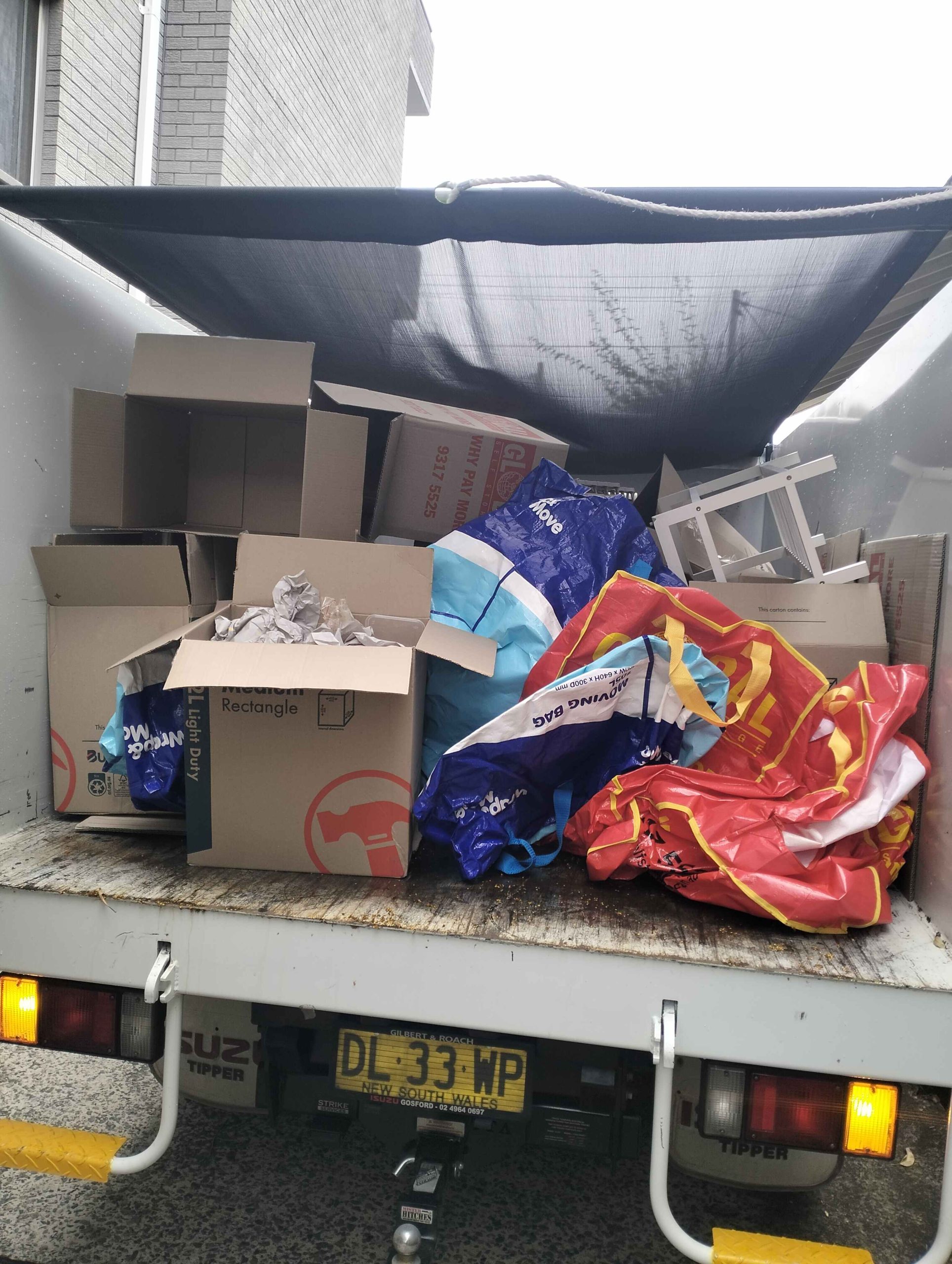 cardboard boxes on the back of otg rubbish removals truck in coogee, Sydney