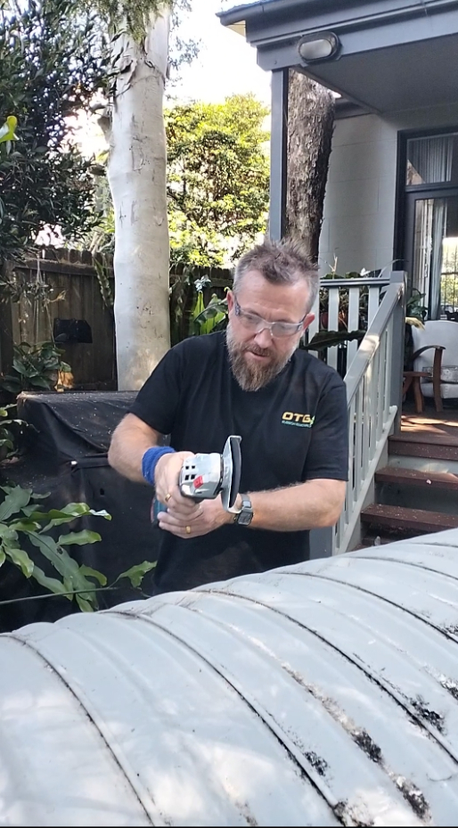 otg rubbish removal team member with grinder